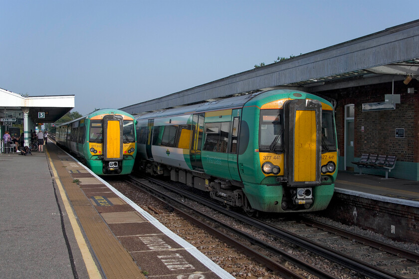 377310, SN 17.05 Bognor Regis-Littlehampton (2P33, 1E) & 377441, SN 15.35 London Victoria-Bognor Regis (1B42, RT), Barnham station 
 A meeting of Southern Electrostars at Barnham station. Under a brilliant blue sky 377310 to the left pauses with the 17.05 Bognor Regis to Littlehampton shuttle service. The distance by rail is a mere eight miles whilst it is even less by road using the A259 however, it is connections to the mainline that are probably of greater importance. To the right 377441 arrives with the 15.35 Victoria to Bognor Regis service. 
 Keywords: 377310 17.05 Bognor Regis-Littlehampton 2P33 377441 15.35 London Victoria-Bognor Regis Barnham station Southern Electrostar