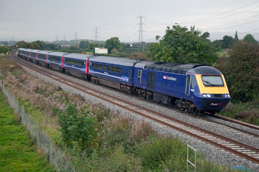 43194 & 43009, GW 15.06 London Paddington-Penzance (1C86) Berkley ST808497 
 43194 and 43009 have slowed right down as they past Berkley near to Frome with the 15.06 Paddington to Penzance. The reason for its sedate progress at this point was that it was following the previous stone train hauled by 60039 'Dove Holes' that had just cleared the mainline at Clink Road Junction about a mile west of here. Note the squall that was heading straight for me, just giving just enough time to get back in my Combo van before the heavens opened; time to head back to mum's for a cup of tea I think! 
 Keywords: 43194 43009 15.06 London Paddington-Penzance 1C86 Berkley ST808497