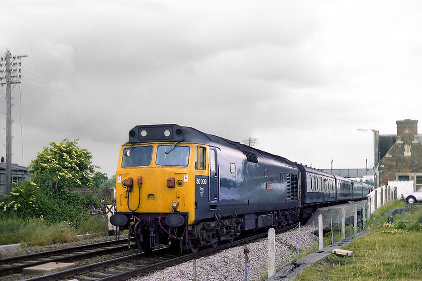 50009, unidentified down working, Pewsey station 
 50009 'Conquerer' leaves Pewsey station with an unidentified down working heading for the West Country. Pewsey station was bit down on its luck back in 1978 and did not enjoy a great service pattern. However, on my most recent visit last year in 2017 it had gone through a total renaissance looking very smart and with a huge and very full carpark indicating that patronage was healthy! 
 Keywords: 50009 down working Pewsey station