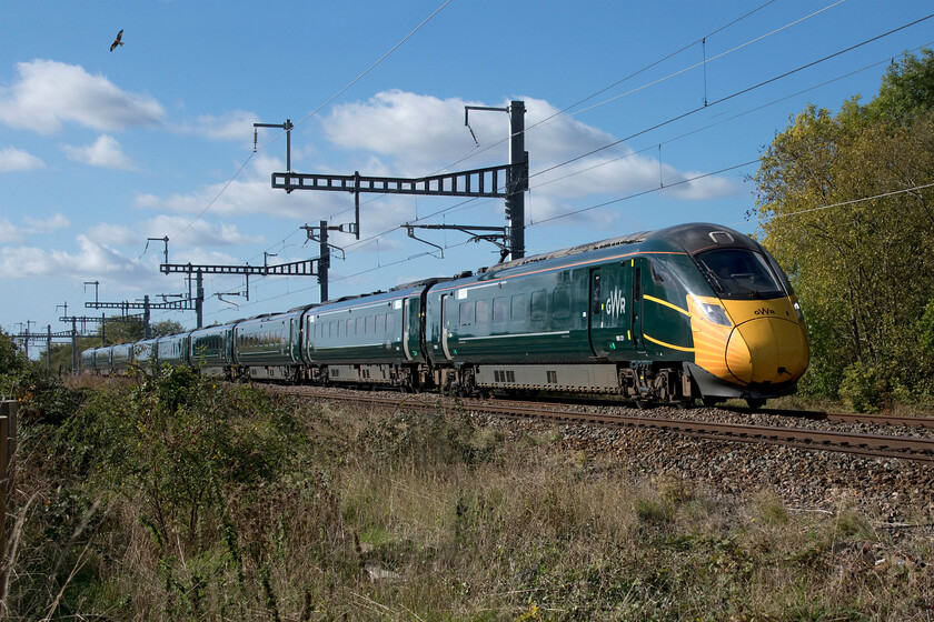 800321, GW 09.10 Penzance-London Paddington (1H32, RT), Uffington SU306904 
 800321 passes Uffington working the 1H32 09.10 Penzance to Paddington (Via Bristol) GWR service. The IET still wears its COVID facemask applied back in June 2020 during the darkest months of the pandemic. Notice in this scene the red kite (milvus milvus) soaring above the train on the warm early afternoon thermals. 
 Keywords: 800321 09.10 Penzance-London Paddington 1H32 Uffington SU306904