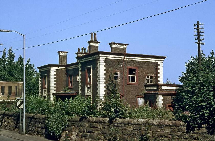 Mostyn station (closed) 
 Another of the Francis Thompson designed stations that lined the North Wales coast is seen at Mostyn. When this photograph was taken in 1981 it was derelict and looking very sorry for itself having been closed some fifteen years previously on 01.05.66. When I last passed the station, located directly on the A548 coast road, it had been renovated and was back in use as a private residence, see....https://www.ontheupfast.com/p/21936chg/30021093929/mostyn-station. 
 Keywords: Mostyn station closed