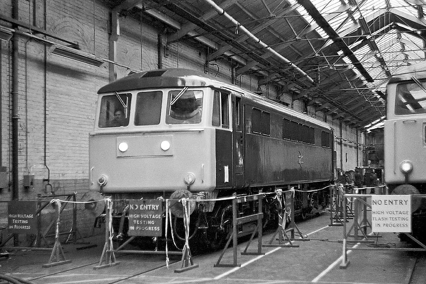 86019 & 83014, Crewe Works 
 In the electrical testing shop at Crewe Works, 86019 is seen next to 83014. Looking at their shiny paintwork, they are at the end of the overhaul process and being tested ready for release into traffic. Notice the mysterious person sitting at the secondman's seat the cab of 86019. 
 Keywords: 86019 83014 Crewe Works