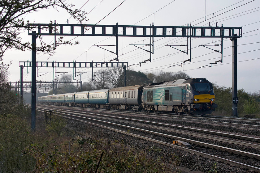 68034, outward leg of The Snowdonia Panorama, 07.09 London Euston-Llandudno (1Z23), Ashton Road bridge 
 Class 68s on passenger services are not very common, even if they are charters. 68034 leads the The Snowdonia Panorama that started out from Euston at 07,09 ending up at Llandudno. On its return journey it started from Bangor having spent the intervening time being serviced at Holyhead that involved a return ECS run across Anglesey. As can be seen, the train is on the down fast taking the Weedon loop line thus reaching Rugby in front of the previous charter going to Liverpool that took the slower route via Northampton. 
 Keywords: 68034 The Snowdonia Panorama 07.09 London Euston-Llandudno 1Z23 Ashton Road bridge