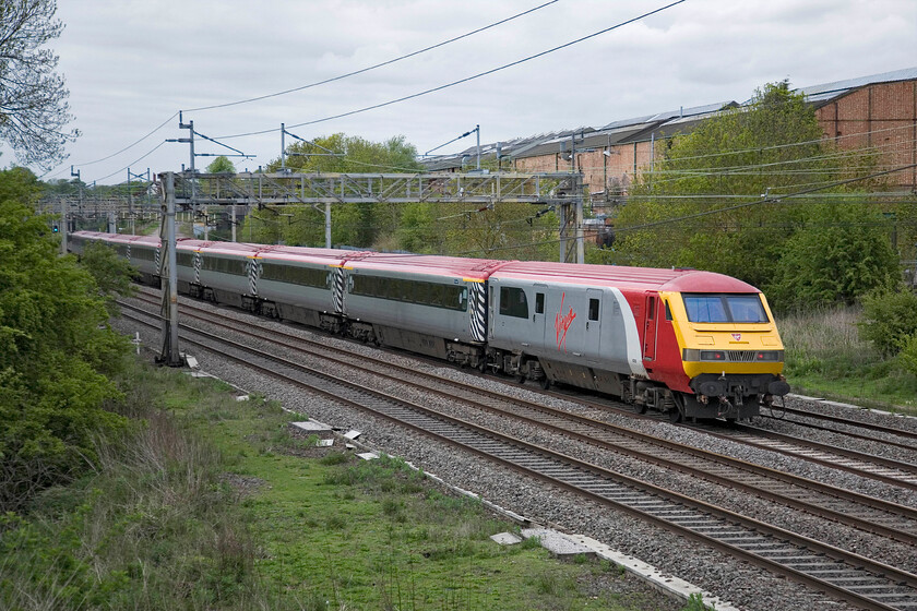 82126, LM 16.50 London Euston-Northampton Footex (1T16), Roade 
 The rear of the 16.50 Euston to Northampton football special passes Roade with DVT 82126 at the tail end. Chartered by London Midland and running as 1T16 the train was bringing disappointed Cobblers supporters home following their 3-0 defeat by Bradford City in the League Two payoff at Wembley. 
 Keywords: 82126 16.50 London Euston-Northampton Footex 1T16 Roade Vigin Pretendolino