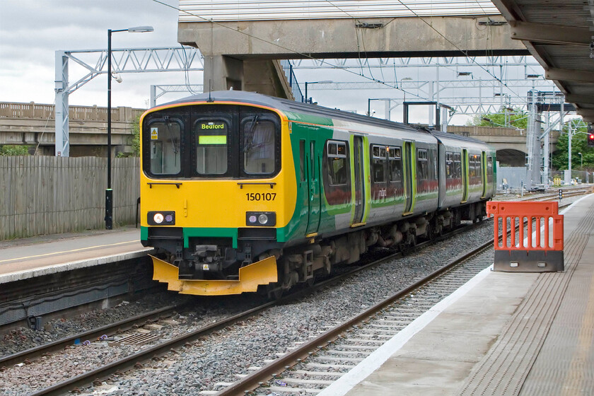 150107, LM 14.01 Bletchley-Bedford, Bletchley station 
 150107 is about to depart from Bletchley with the 14.01 service to Bedford. The Class 150s, despite their age, are proving successful on the Marston Vale line despite them having to return to Tysley every weekend for servicing and swapping with another unit. 
 Keywords: 150107 14.01 Bletchley-Bedford, Bletchley station