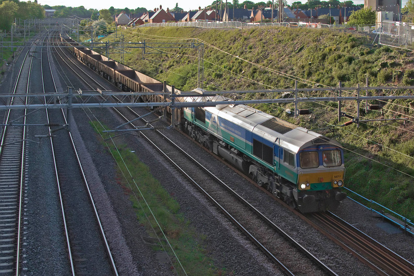 66711, 17.38 Bescot-Camden Junction (7G52, 19L), Ashton Road bridge 
 Despite its livery, this is a GBRf locomotive. 66711 'Sence' leads the 17.38 Bescot to Camden Junction infrastructure train past Ashton Road bridge just south of Roade. The sun has got really low in the sky by this time in the evening but, nonetheless, I really like the lighting in this photograph even if it did need a little extra Photoshop treatment! 
 Keywords: 66711 17.38 Bescot-Camden Junction 7G52 Ashton Road bridge Sence