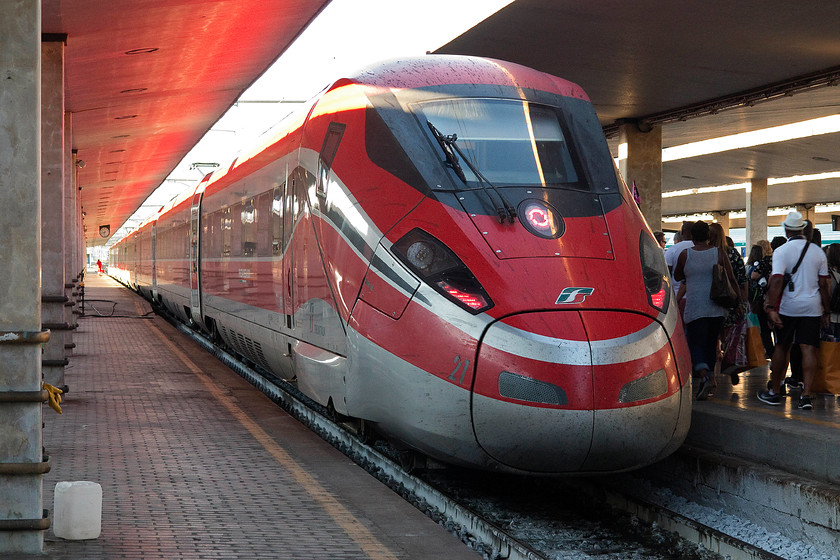 500.004, 16.25 Venice SL-Naples C (9443), Florence SMN station 
 Passengers walk along the platform ready to board the 16.25 Venice to Naples 9443 high speed service. The service is being worked by a Frecciarossa 1000 HST number 500.004. Notice the red reflection from its roof on the underside of the station canopy. 
 Keywords: 500.004 16.25 Venice SL-Naples C 9443 Florence SMN station