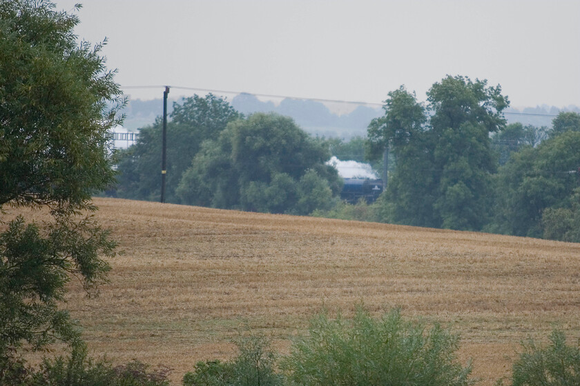 60163, outward leg of The Cathedrals Express, 07.40 London Euston-Worcester (1Z39), from Charlie's bedroom window 
 What was I to do? Celebrity 'new build' 60163 was due to pass close to home in Roade but it was a dreadfully wet day with relentless rain from dawn. Had I ventured out the shot would have been very poor and I would have got soaked into the bargain. So still dry and in my pyjamas, I settled on this position from the comfort of my son's bedroom window! The locomotive is just seen through a gap in the trees leading the outward leg The Cathedrals express that left Euston at 07.40 running as 1Z39 and heading for Worcester. 
 Keywords: 60163 The Cathedrals Express 07.40 London Euston-Worcester 1Z39 from Charlie's bedroom window Tornado