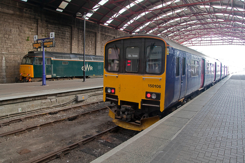 57602, 08.22 Penzance-Penzance MPD ECS (5C99) & 150106, GW 08.57 Penzance-St.Ives (2A07, RT), Penzance station 
 Under the lovely train shed at Penzance, 57602 is waiting to be towed out to the MPD for the Sleeper that is hauled from Paddington to be serviced. Meanwhile, 150106 waits to work the 08.57 to St. Ives. The station was opened in 1852 by the West Cornwall Railway and is 327 miles from Paddington. 
 Keywords: 57602 08.22 Penzance-Penzance MPD ECS 5C99 150106 2A07 Penzance station