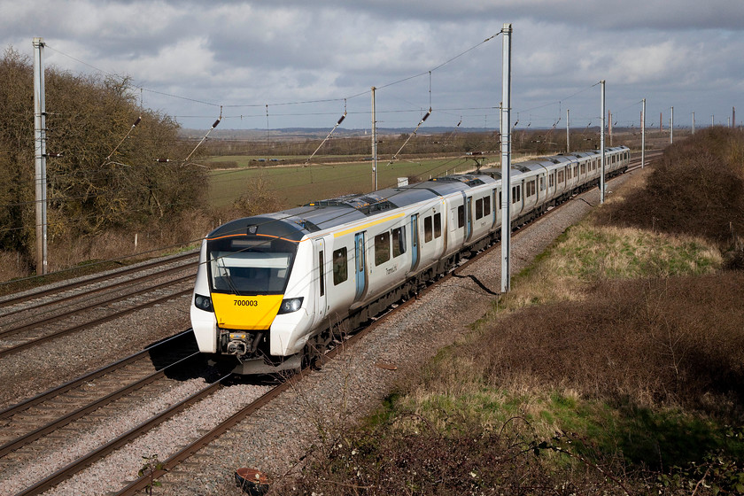 700003, TL 09.54 Bedford-Three Bridges (2W27, 2L), Millbrook TL020397 
 700003 heads south past Millbrook with the 09.54 Bedford to Three Bridges. Thameslink service. The 700s are the third generation of electrics to ply their trade on this route since it was electrified. Initially the 313s were intriduced, then the class 319s. One wonders how long the 700s will operate before being moved or cascaded as it is colloquially referred to? 
 Keywords: 700003 2W27 Millbrook TL020397