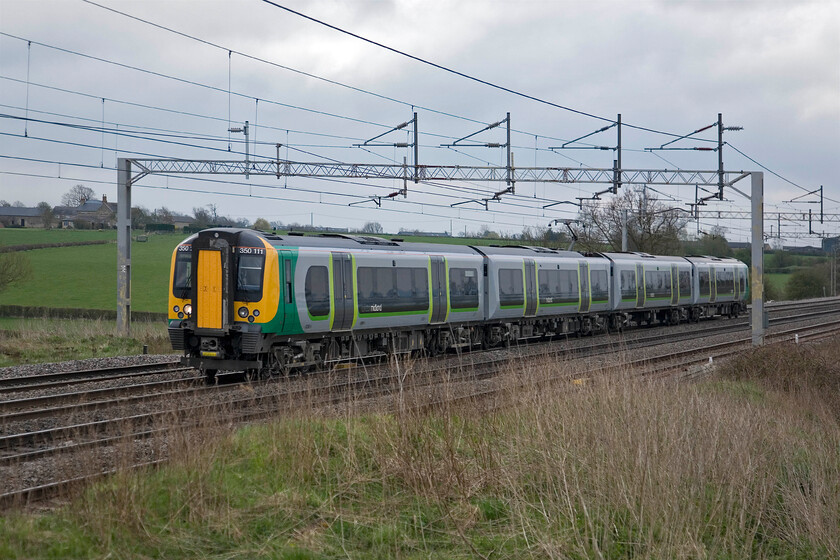 350111, LM 07.49 London Euston-Birmingham New Street, Gordon's Lodge SP776483 
 On a very grey and dull late April morning, 350111 passes near Gordon's Lodge just north of Hanslope Junction working the 07.49 Euston to Birmingham London Midland service. 
 Keywords: 350111 07.49 London Euston-Birmingham New Street Gordon's Lodge SP776483 London Midland desiro