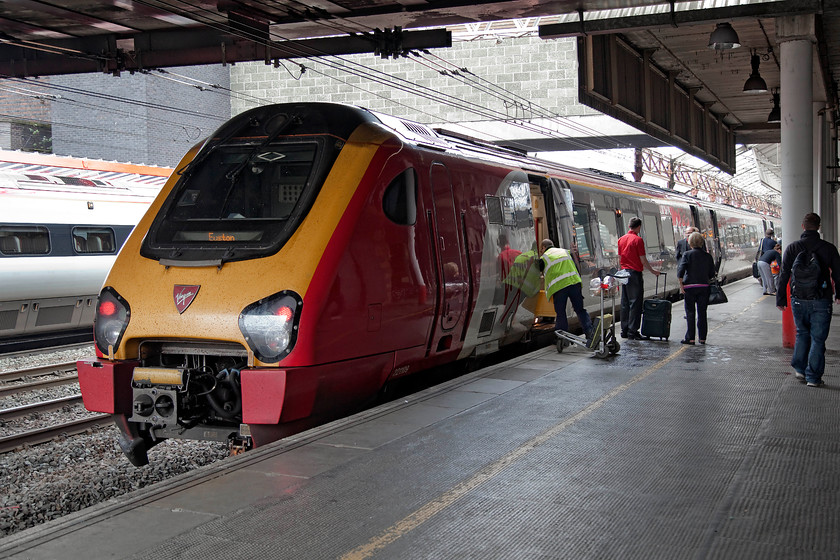 221109, VT 08.55 Holyhead-London-Euston (1A23), Crewe station 
 At Crewe station, the rear of the 08.55 Holyhead to Euston is seen with a passenger's needs being attended to by train and platform crew. The service is being worked by 221109 'Marco Polo'. 
 Keywords: 221109 08.55 Holyhead-London-Euston 1A23 Crewe station