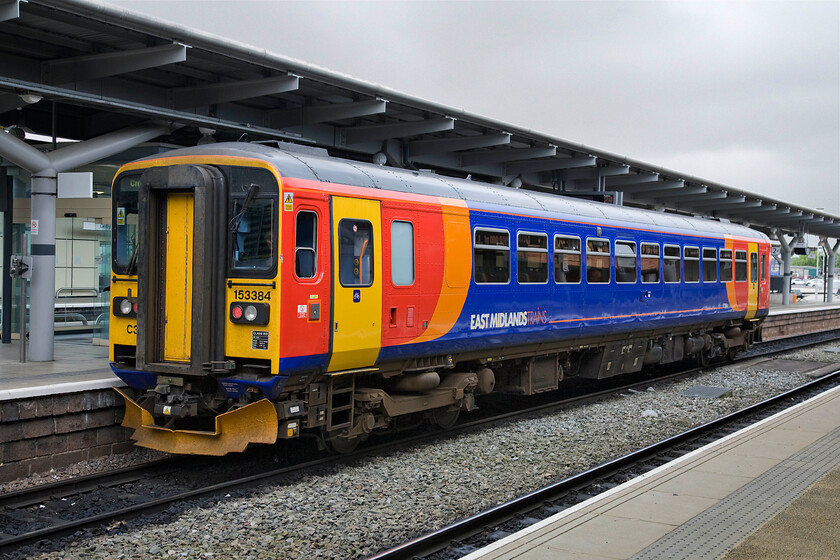 153384, EM 10.42 Derby-Crewe (1K99), Derby station 
 In its EMT livery 153385 adds a splash of colour to an otherwise grey station on an equally grey day! The single-car service is preparing to leave Derby station with the 1K99 10.42 service to Crewe. 
 Keywords: 153384 10.42 Derby-Crewe 1K99 Derby station EMT East Midlands Trains