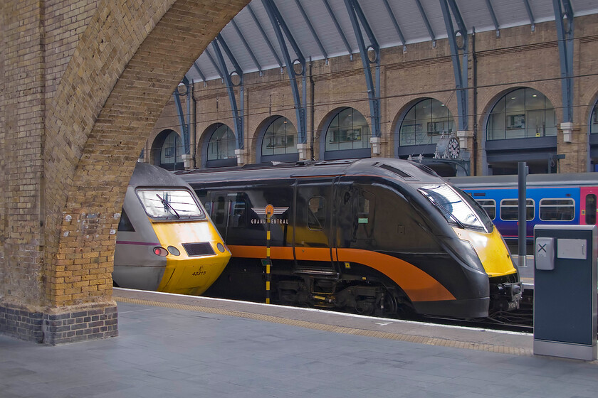 43315, GR 06.55 Skipton-London King's Cross (1A13) & 180107 GC 06.55 Bradford Interchange-London King's Cross, London King's Cross station 
 The restoration of King's Cross has been an absolute triumph that has totally revitalised the superb station. After years of dirt and grime have been removed the lovely warm London stock brickwork has been revealed in all its glory once again. Viewed through one of the arches that has been so treated 43315 is seen having led the 06.55 from Skipton. The more modern look of Grand Central's 180107 is a marked contrast to the elderly HST. The GC service has also just arrived as the 06.55 from Bradford Interchange. 
 Keywords: 43315 06.55 Skipton-London King's Cross 1A13 180107 06.55 Bradford Interchange-London King's Cross London King's Cross station East Coast HST Grand Central Aldente