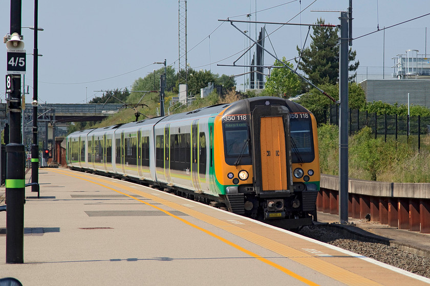 350118, LM 13.14 Birmingham New Street-London Euston (1Y46, 13L), Milton Keynes station 
 The 1Y46 13.14 Birmingham New Street to Euston arrives at Milton Keynes station formed of 350118. A beltingly hot day ironically, one that made photography quite tricky with the extremely strong and overhead lighting. Notice that I resit calling Milton Keynes by its network Rail name, Milton Keynes 'Central'. As there is only one station in Milton Keynes, with no prospect of another, then Central is superfluous and somewhat ostentatious! 
 Keywords: 350118 1Y46 Milton Keynes station