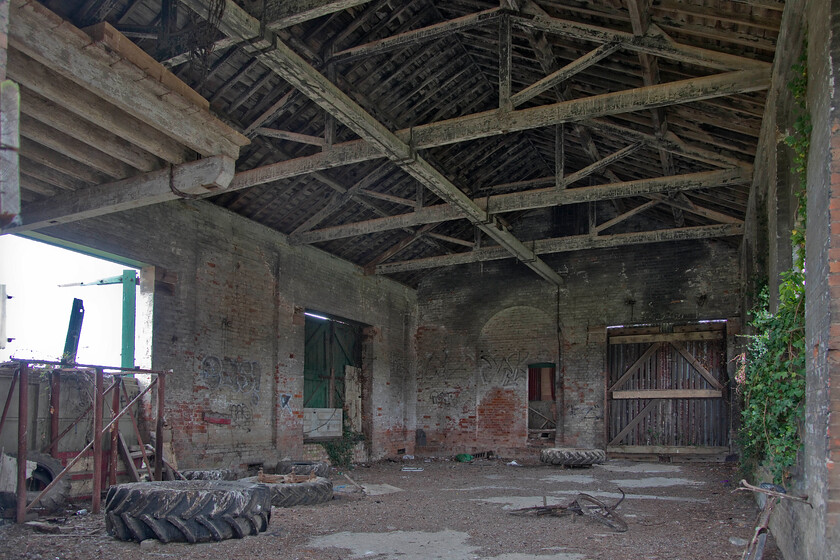 Interior, former goods shed, Cowbit 
 The interior of Cowbit goods shed is impressive, particularly the substantial roof structure. When in use the shed would have handled local goods both in and out for Cowbit and the surrounding area in an era when things were so different than today. I cannot help but think that such a superb and intact structure is crying out to be repurposed. The building of houses adjacent to it on the former trackbed suggests that things may be happening soon. 
 Keywords: Interior former goods shed Cowbit