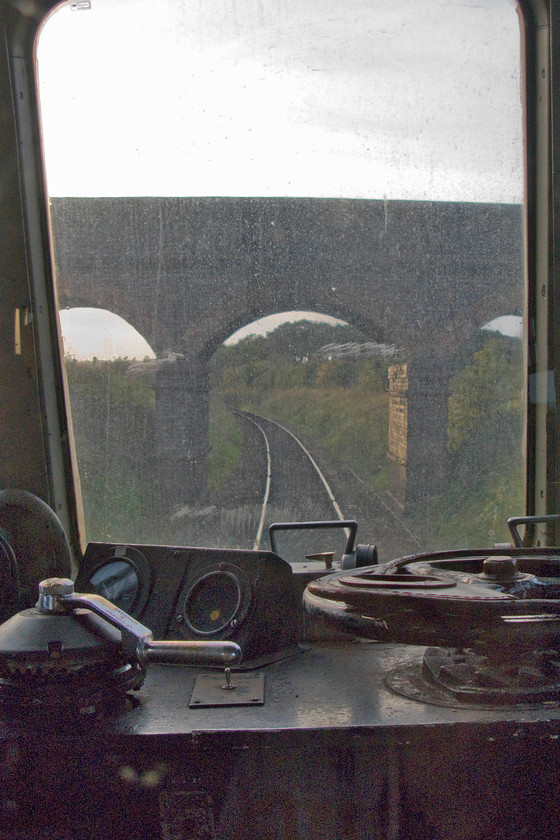 M51192 & M56352, 15.45 Sheringham-Holt, Dead Man`s Hill bridge 
 One can see the attraction of first-generation DMUs to heritage lines and their many visitors in this photograph. They offer unrivalled front and rear views through the driver's cab (if the blinds are not drawn!) of the routes that the lines follow, in the case of the NNR a mixture of coastal views, heathland and Norfolk countryside. Taken through the leading window of M51192 the unusually named Dead Man's Hill bridge is about to be passed that is a favourite vantage point for many photographers. 
 Keywords: M51192 M56352 15.45 Sheringham-Holt Dead Man`s Hill bridge Class 101 DMU