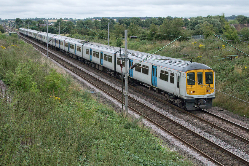 319218 & 319005, LN 07.45 London Euston-Northampton EMUD (5N10, 12E), Milton Malsor SP738560 
 Former Thameslink units 319218 and 319005 (plus an unidentified unit in the centre) work back empty from London to London Northwestern's Kingsheath depot as the 5N10 past Milton Malsor near Northampton. They will have worked up in the morning normally being packed with commuters. However, at the present time, despite the easing of the COVID-19 restrictions, the three-unit twelve-car train will have been virtually empty as very few people are returning to their previous commuting patterns. London Northwestern has still not branded the majority of these units that are only used at peak times as they will be disposed of soon. 
 Keywords: 319218 319005 07.45 London Euston-Northampton EMUD 5N10 Milton Malsor SP738560 Thameslnk