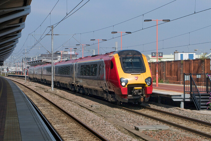 Class 221, 09.50 Birmingham New Street-London Euston (1B28), Rugby station 
 The 09.50 Birmingham to Euston Virgin service gets away from its stop at Rugby being worked by an unidentified Class 221 Voyager. The train is leaving from the recently completed island platform (platforms five and six) to the north side of the station. 
 Keywords: Class 221 09.50 Birmingham New Street-London Euston 1B28 Rugby station Virgin Voyager