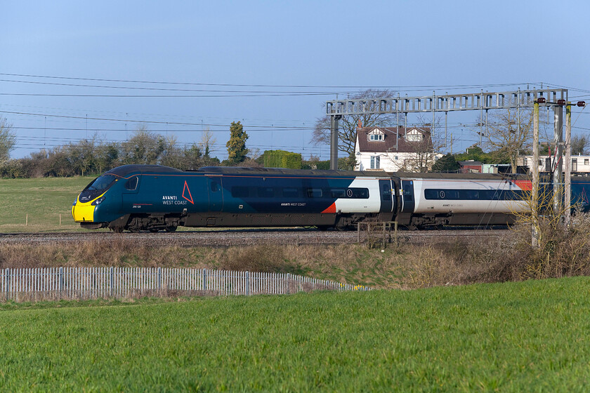 390128, VT 06.10 Manchester Piccadilly-London Euston (1A05, 3L), between Roade & Ashton 
 390128 'City of Preston' passes between the villages of Roade and Ashton working the 1A05 06.10 Manchester to Euston Avanti service. For a change this morning, I used my Canon 5D as I knew that the photograph that I had in mind for the steam charter would need a faster shutter speed than the G1X could offer. This Pendolino has been frozen using 1:4000/second with anything less meaning some motion blur would be evident. 
 Keywords: 390128 06.10 Manchester Piccadilly-London Euston 1A05 between Roade & Ashton City of Preston