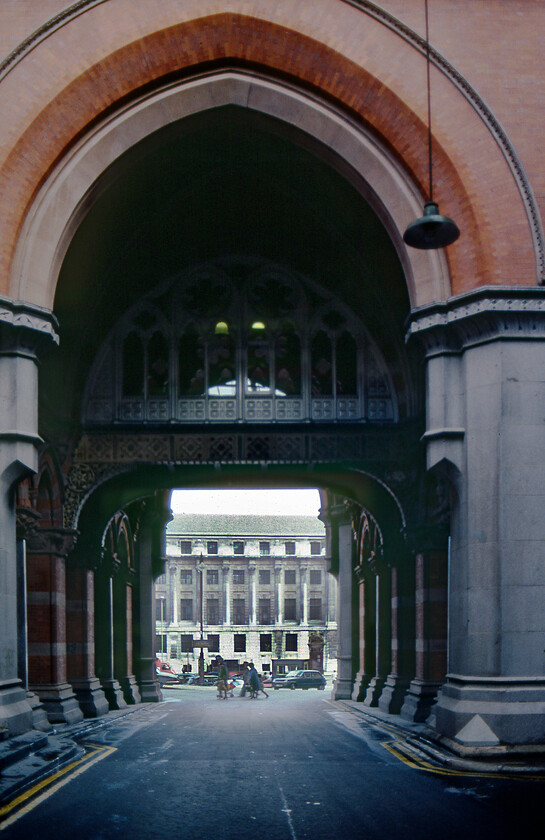 Archway, London St. Pancras station 
 One of the archway entrances to St. Pancras station that allowed vehicles to access the interior is seen looking towards Euston Road. The George Gilbert Scott designed Grand Midland Hotel through which access was gained was at this time being used by BR as offices. Today, after becoming a hotel again, access through this archway is undertaken in a somewhat different manner being pedestrians only with all vehicles banished. 
 Keywords: Archway London St. Pancras station