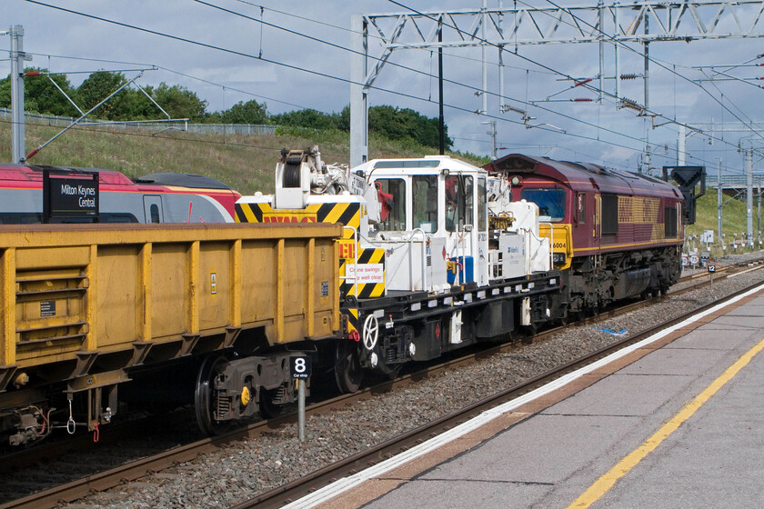 66004, unidentified Wembley Yard-Bescot infrastructure working (7R03), Milton Keynes station 
 Being a Sunday and with no trains in or out of Northampton until much later in the day we decided to drive and park at Milton Keynes rather than take the dreaded bustitution option! On arrival at Milton Keynes an engineering train was stationary through the entire length of the station. At the northern end of the Wembley Yard to Bescot train 66004 would lead the train that would be forced to take the Weedon route rather than through Northampton much to the frustration of the drivers of any following Vrgin or London Mdnad drivers! 
 Keywords: 66004 Wembley Yard-Bescot infrastructure working 7R03 Milton Keynes station.jpg