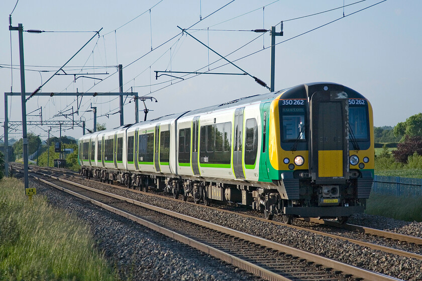 350262, LM, 19.25 Northampton-London Euston, Milton Malsor SP740553 
 350262 passes Milton Malsor working the evening's 19.25 Northampton to Euston London Midland Service. Whilst it is a smashing midsummer's evening threatening cloud is beginning to build from the east just out of sight in this photograph. 
 Keywords: 350262 19.25 Northampton-London Euston Milton Malsor SP740553 London Midland desiro