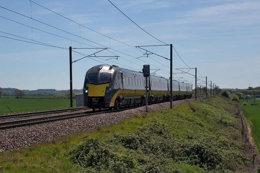 Class 180, GC 11.27 London King`s Cross-Sunderland (1N92, 1E), Frinkley Lane crossing SK906436 
 I have visited Frinkley lane crossing, that is located between Barkston Junction and Claypole on the ECML, a number of times and it remains one of my favourite spots for a number of reasons, largely because the surroundings are pretty remote and quiet. However, as the line is running north-south lighting can be tricky at certain times in the day as illustrated in this image. One of Grand Central's ten class 180s heads north with the 11.27 King's Cross to Sunderland. Until 2017, Grand Central operated a mixed fleet combining 180s and HSTs. However, after GWR dispensed with its remaining class 180 units, Grand Central acquired them and disposed of its HSTs that themselves moved East Midlands Trains; I think that this is euphemistically referred to as 'cascading'! 
 Keywords: Class 180 11.27 London King`s Cross-Sunderland 1N92 Frinkley Lane crossing SK906436