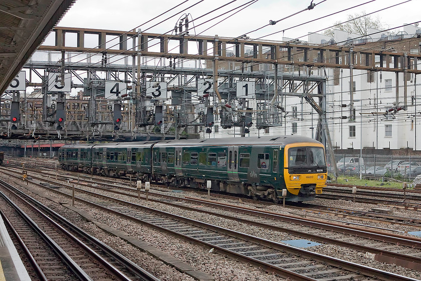 166210, GW 14.50 London Paddington-Oxford (1D30, 4L), Royal Oak LU station 
 Taken from Royal Oak LU station 166210 passes with the 14.50 Paddington to Oxford service. Notice the car park in the background, this used to be the site of the Ranelagh Bridge fuelling depot that closed in 1980. 
 Keywords: 166210 1D30 Royal Oak LU station