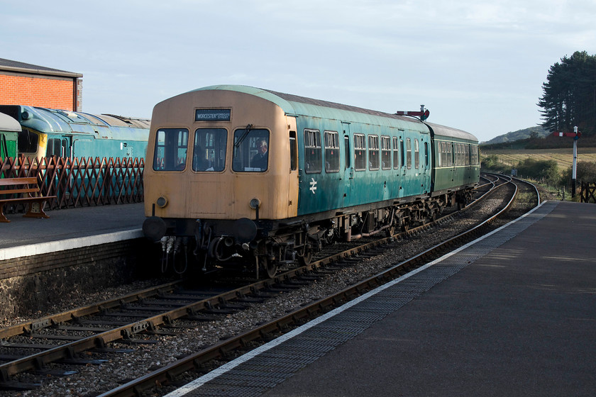 25057, stabled, M51188 & M56352, 09.55 Sheringham-Holt, Weybourne station 
 Early morning at Weybourne sees the first service of the day, the 09.55 Sheringham to Holt arrives wrong line in to the station. It is formed of two class 101 DMU cars, M51188 and M56352, one in BR blue and the other in British Railways green. Stabled in the bay platform is 25057 that is, according to the NNR web site, 'stored and out of service'; sounds ominous doesn't it? 
 Keywords: 25057 stabled M51188 M56352 09.55 Sheringham-Holt Weybourne station