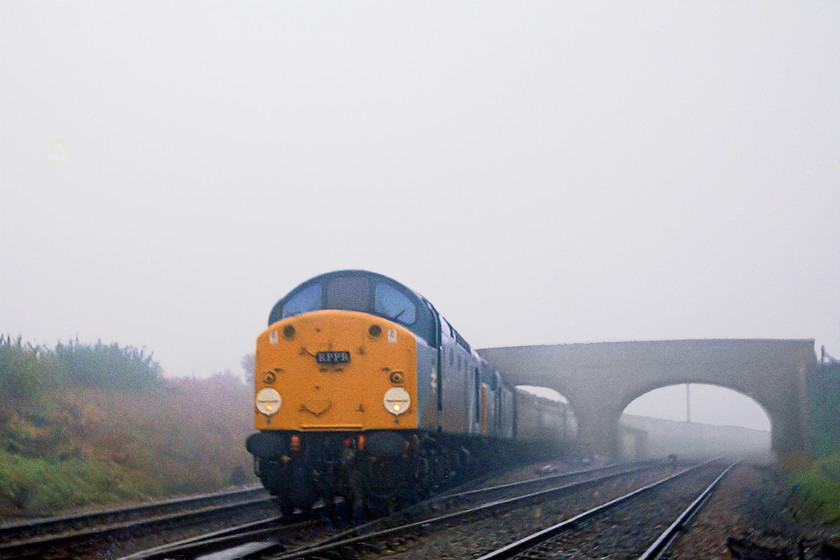 40081 & 40083, outward leg of the Deltic to Devon Cromptons to Cornwall, London Paddington-Newton Abbot Par (1Z30), Fairwood Junction. 
 Due to an unofficial industrial dispute over to the proposed closure of Finsbury Park depot and its moving to Bounds Green, staff were 'blacklisting' Deltics. As a result of this, all were confined to depots from 17th to 21st October 1977. Unfortunately, this coincided with the running of the RPPR's Deltic to Devon railtour. The RPPR did not want to cancel the railtour, so, after discussions with the Easter Region's CM & ME two class 40s we're provided. Here, the duo lead the railtour past a very foggy Fairwood Junction at Westbury running as 1Z30 from London Paddington to Newton Abbot. From there, a pair of 33s took the railtour on to Par