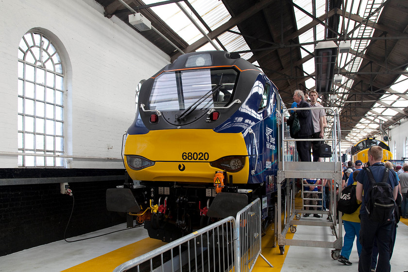 68020, on-display, DRS-Gresty Bridge 
 Cabbing 2016 style! A queue of enthusiasts wait on the steps in order to access 68020 'Reliance' inside DRS's immaculate Gresty Bridge depot. The depot opened nine years ago in 2007 having been originally been built by the GWR as a wagon repair shop. The wall and window to the left gives clues to its earlier life. 
 Keywords: 68020 DRS-Gresty Bridge