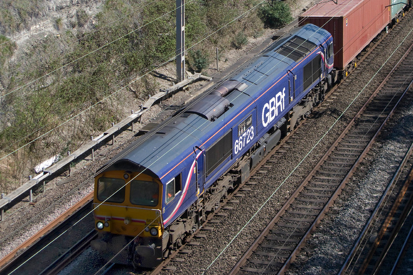 66723, 10.46 Felixstowe North-Hams Hall (4M23), Roade cutting 
 66723 'Chinook' leads the 10.46 Felixstowe North to Lawley Street Freightliner service through Roade cutting. The poor initial framing of the train led me to undertake some dramatic cropping to produce this somewhat different view of the locomotive. At least its large nameplate can be seen, that was unveiled at a ceremony at Wellingborough on 02.09.07 by John Smith, Managing Director of First GBR and the then Station Cdr at RAF Odiham, Group Captain Andy Turner in support of the Royal Air Force. It carries the three squadron plaques of seven, eighteen and twenty-seven Squadron, the three frontline Squadrons at RAF Odiham in Hampshire. 
 Keywords: 66723 10.46 Felixstowe North-Hams Hall 4M23 Roade cutting Freightliner Chinook