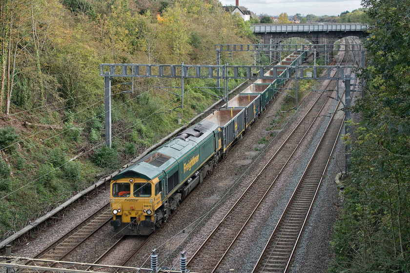 66616, 13.17 Willesden down sidings-Tunstead (6H50, 54L), Hyde Road bridge 
 Although in the timetable every day this particular working does not operate very often. 66616 leads the 6H50 Willesden to Tunstead empty stone train on the southern approaches to Roade cutting. The return loaded working is also a little unreliable and often is routed via the MML crossing to the WCML via the Marston Vale line. 
 Keywords: 66616 13.17 Willesden down sidings-Tunstead 6H50 Hyde Road bridge Freightliner Heavy Haul