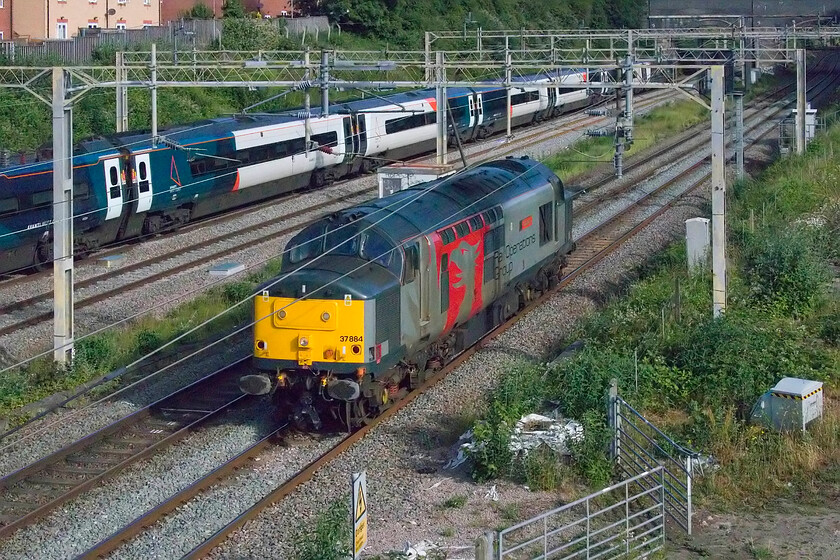 37884, 05.39 Derby RTC-Wembley HS (0O87, 15E) & 390124, VT 07.30 London Euston-Glasgow Central (cancelled from Preston) (1S42, RT), site of Roade station 
 Rail Operations Group 37884 'Cepheus' runs light engine through Roade as the 0O87 Derby RTC to Wembley HS positioning move. I am not sure what work the veteran Class 37 was heading south for but they have been involved in the conveyance of a number of scrap unit runs to Sims Group at Newport. 390124 heads north on the down fast line working the 07.30 Euston to Glasgow Central, the first down Anglo Scottish AWC service of the day. 
 Keywords: 37884 05.39 Derby RTC-Wembley HS 0O87 390124 07.30 London Euston-Glasgow Central 1S42 site of Roade station AWC Avanti Pendolino ROG Rail Operations Group Cepheus Europheonix