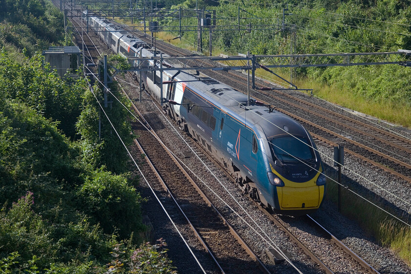 390002, VT 07.48 London Euston-Edinburgh Waverley (9S54, 11L), Victoria bridge 
 The first down Sunday Avanti service of the day passes Victoria bridge near Roade on the slow line catching some welcome sunshine. 390002 'Stephen Sutton' is working the 9S54 07.48 Euston to Edinburgh arriving at its destination just after lunchtime. 
 Keywords: 390002 07.48 London Euston-Edinburgh Waverley 9S54 Victoria bridge Avanti West Coast Pendolino Stephen Sutton