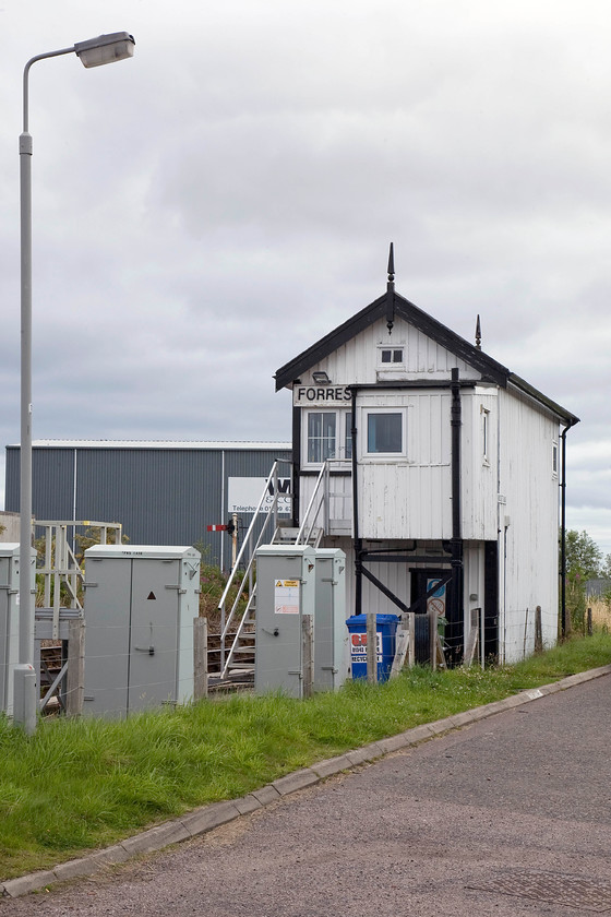 Forres signal box (McK&H & High, 1896) 
 Of the three boxes that once existed at Forres, this is the only remaining example, once named Forres East. It's a McKenzie and Holland Highland example dating from 1896 that once boasted a large forty-two lever frame now much reduced. Notice the steps between the lamp post and the relay box for the signalmen to climb in order to ease the exchanging of the tokens. 
 Keywords: Forres signal box