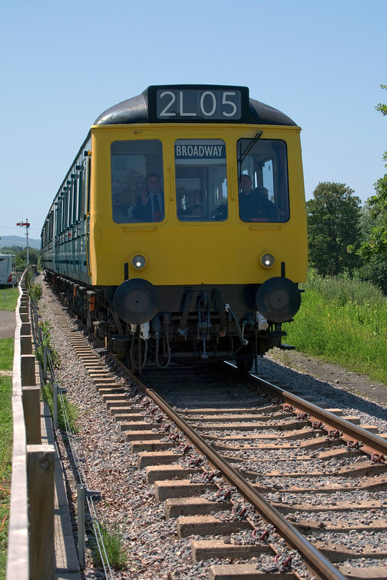 W51360, W59510 & W51363, 12.20 Cheltenham Racecourse-Broadway, Broadway caravan site 
 Technically a pretty poor picture taken into the strong summer sun but one I want to include as it shows one of the GWSR class 117 DMUs arriving at their new Bradway terminus. It is seen passing the Broadway caravan site where the old goods shed has cleverly been put to use by the site. As well as having some covered space it also contains showers and toilets for the happy caravaners! The DMU arrives with the 12.20 from Cheltenham racecourse. 
 Keywords: W51360 W59510 W51363 12.20 Cheltenham Racecourse-Broadway Broadway caravan site