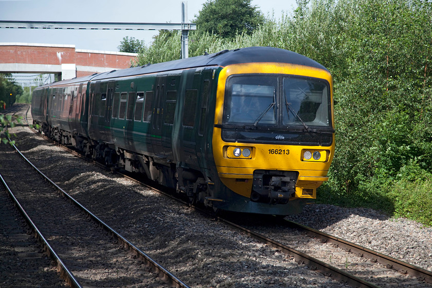 166213, GW 09.39 Bedwyn-London Paddington (1K45, 3L), Aldermaston station 
 'Turbo' 166213 arrives at Aldermarston station on the Berks and Hants line just west of Reading working the 09.39 Bedwyn to Paddington local service. Notice that the signs of change are all around from the raised bridge in the background to the more obvious electrification stanchion crossing the line. 
 Keywords: 166213 1K45 Aldermaston station