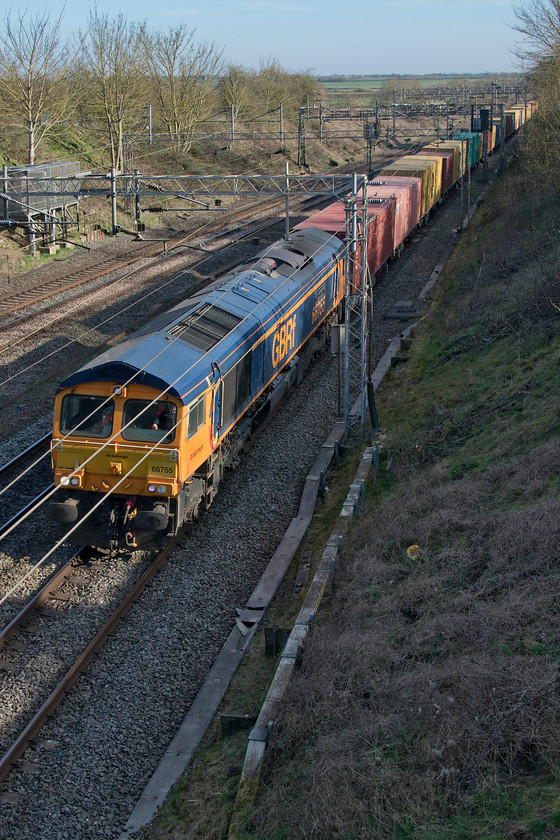 66755, 12.05 London Gateway-Hams Hall (4M46, 7L), Victoria bridge 
 As a sign of the times, the 4M46 12.05 London Gateway to Hams Hall Freightliner led by 66755 'Tony Berkeley OBE RFG Chairman 1997-2018' gets a move on past Victoria bridge heading north but on the fast line travelling via Weedon rather than Northampton. On any normal day, this would be unheard of with fast Pendolinos stacking up behind it. However, things are not normal and with the emergency timetable now in place gaps were found to push freight through as these have become more of a priority than passenger services now. 
 Keywords: 66755 12.05 London Gateway-Hams Hall 4M46 Victoria bridge Tony Berkeley OBE
RFG Chairman 1997-2018