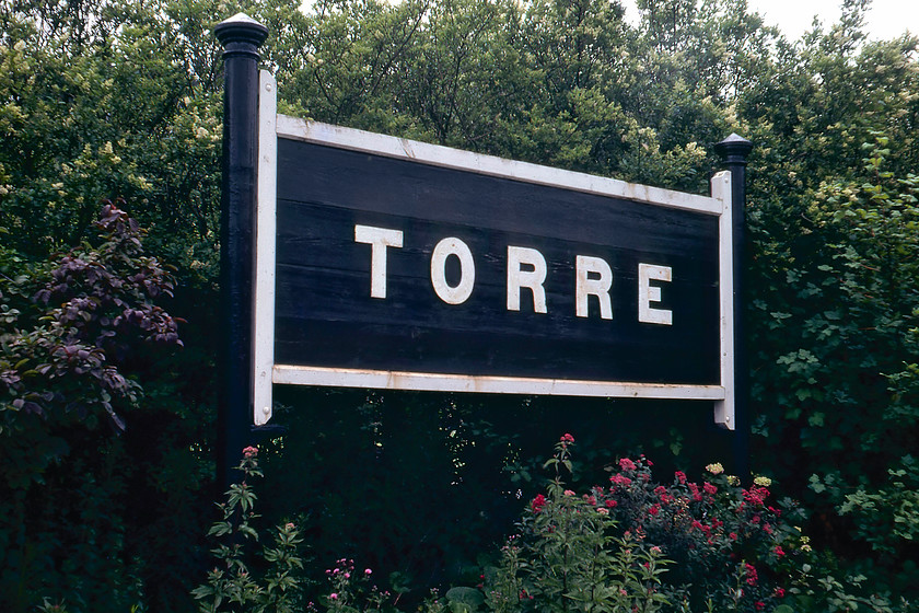 Running in board, Torre station 
 A timber running-in board on Torre station. I am not sure as to its history and if it is a genuine GWR sign or a reproduction - local knowledge anybody? I do know that it still exists today but that it has a slightly different paint scheme, see..... https://www.ontheupfast.com/p/21936chg/24745327604/running-boards-bench-torre-station 
 Keywords: Running in board Torre station