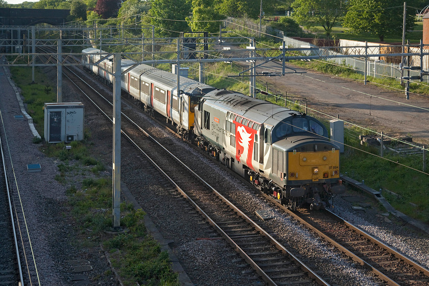 37884 & 317884, 11.38 Kilmarnock Bonnytown-Ilford EMUD (5Q08, 5E), site of Roade station 
 Having worked north the previous day, see...... https://www.ontheupfast.com/p/21936chg/29025173804/x37884-317348-16-12-ilford-emud-kilmarnock 37884 'Cepheus' heads south again this time towing Greater Anglia's 317884. The combo is returning as the 11.38 Kilmarnock Bonnytown to Ilford 5Q08 with the unit having received attention at the Wabtec plant that, unfortunately, is set for closure with all work moving to Doncaster. 
 Keywords: 37884 317884 11.38 Kilmarnock Bonnytown-Ilford EMUD 5Q08 site of Roade station Cepheus ROG Rail Operations Group Greater Anglia GA Europheonix