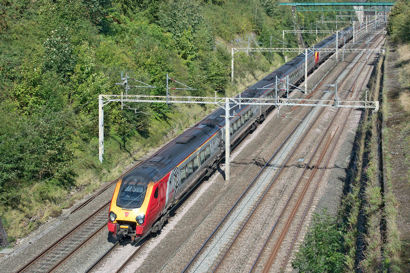 Class 221s, VT 05.49 Glasgow Central-London Euston (9M48, RT), Roade cutting 
 No less than two class 221s pass through Roade cutting working the 05.49 Glasgow Central to Euston service. This, rather unusually, has the headcode of 9M48, one would expect to find that assigned to a freight working rather than that of an passenger express but Virgin has been assigned a class 9 for its Anglo-Scottish services that go via Birmingham since October 2018. 
 Keywords: Class 221 05.49 Glasgow Central-London Euston 9M48 Roade cutting