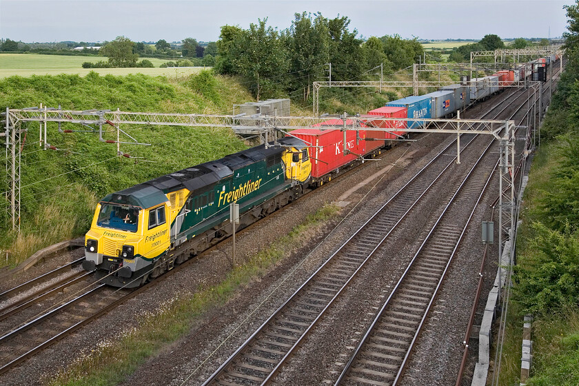 70001, 14.35 Felixstowe North-Lawley Street (4M93), Victoria bridge 
 The weak evening sunshine is just managing to put in an appearance as the 4M93 Felixstowe to Lawley Street Freightliner passes Victoria bridge in Northamptonshire hauled by 700001. Class 70s are not regular performers on the southern section of the WCML so it is good to capture one of these noisy machines! 
 Keywords: 70001 14.35 Felixstowe North-Lawley Street 4M93 Victoria bridge Freightliner