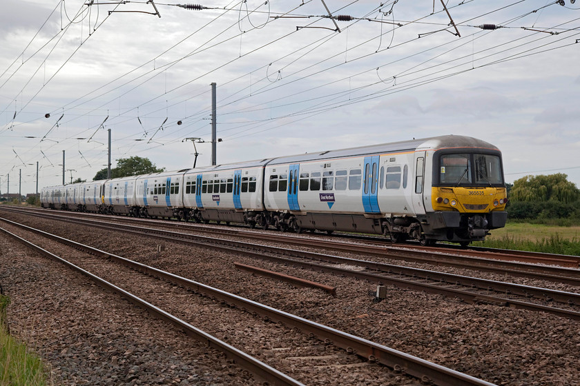 365535 & 365513, GN 09.34 London Kings Cross-Peterborough (2P08, RT), Holme Green Crossing TL192426 
 The 09.34 King's Cross to Peterborough local stopper takes the down slow line past Holmes Green farm crossing as it prepares to slow for its next stop at Biggleswade. This train is composed of 365535 and 365513, that will come off-lease next year when new units are introduced on this line. The future of these Newtworkers is uncertain. 
 Keywords: 365535 365513 2P08 Holme Green Crossing TL192426