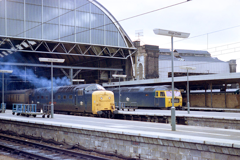 55006, 16.00 London Kings Cross-Edinburgh, The Talisman (1S42) & 47493, unidentified down working, London Kings Cross station 
 55006 'The Fife and Forfar Yeomanry' makes a typically smoky departure from London King's Cross with the 16.00 to Edinburgh titled as 'The Talisman'. Behind the train sits 47493 on an unidentified down working. Whist the Deltic is no longer with us, the Class 47 is  just! It was converted in 1979 to become one of the Scottish Region's push-pull locomotives to speed up the Edinburgh to Glasgow services. It was renumbered 47701 being named 'St. Andrew'. It was renamed 'Waverley' in 1997 and, at the time of writing in 2018, resides at Nemesis Rail in Burton-on-Trent.

There is an audio recording of the engines of 55006 starting its engines here ar King's Cross on my youtube channel, see.... https://www.youtube.com/watch?v=I7Xg9wuJgDI&feature=youtu.be 
 Keywords: 55006 16.00 London Kings Cross-Edinburgh 'The Talisman 1S42 47493, unidentified down working London Kings Cross station