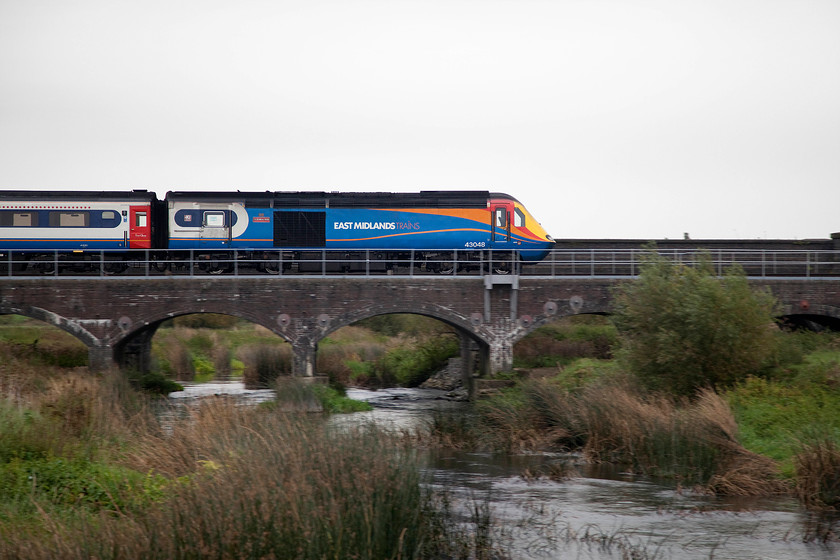 43048, EM 07.30 Nottingham-London St. Pancras (1B18, 1E), Radwell Viaduct TL008569 
 43048 'T.C.B. Miller MBE' leads the 07.30 Nottingham to St. Pancras has just descend from Sharnbrook summit and is now crossing Radwell viaduct. A pan shot really shows off the classic shape of these veteran power cars that were the vision of T.C.B. Miller in the 1960s. He was a career railway engineer who's working life started with the LNER under Sir Nigel Gresley. 
 Keywords: 43048 07.30 Nottingham-London St. Pancras 1B18 Radwell Viaduct TL008569