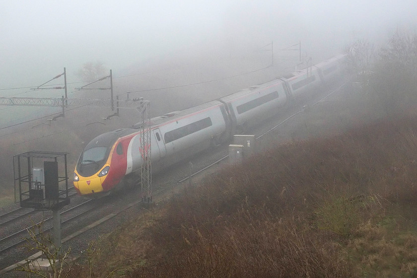 390152, VT 07.35 London Euston-Manchester Piccadilly (1H62, 2L), A45 Weedon bypass bridge 
 390152 'Virgin Knight' passes a very foggy Weedon with the 07.35 Euston to Manchester Piccadilly. The picture is taken from the new A45 road bridge just north of the village. After a very foggy start to the day, within an hour or so, the sun was out and it was a glorious early spring day. 
 Keywords: 390152 07.35 London Euston-Manchester Piccadilly 1H62 A45 Weedon bypass bridge