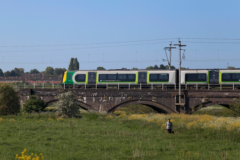 350234, LN 08.33 Birmingham New Street-London Euston (1W06, 6L), Kingsthorpe Meadow 
 The man and his dog appear not to notice 350234 as it comes into Northampton forming the 1W06 08.33 Birmingham New Street to London Euston service. The train is crossing the short viaduct that spans a small brook that is a tributary to the River Nene that it joins in Northampton just by the station. 
 Keywords: 350234 1W06 Kingsthorpe Meadow