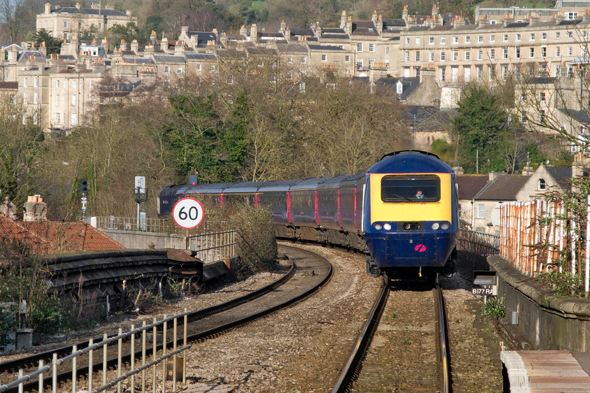 43040 & 43139, GW 15.00 London Paddington-Bristol Temple Meads (1C19), Bath Spa station 
 A view using the camera's zoom to full effect at Bath Spa shows the 1C19 15.00 Paddington to Bristol HST service approaching the station. As well as showing the full length of the HST with power car 43040 'Bristol St. Philip's Marsh' leading with 43139 'Driver Stan Martin 25 June 1950-6 November 2004' bringing up the rear some of Bath's Georgian grandeur is in view. The fine stone townhouses that cling to the hillside, constructed of locally mined oolitic limestone, are centred around Bathwick Hill, one of the most desirable addresses in the city. 
 Keywords: 43040 43139 15.00 London Paddington-Bristol Temple Meads 1C19 Bath Spa station First Great Western HST Bristol St. Philip's Marsh Driver Stan Martin 25 June 1950 - 6 November 2004